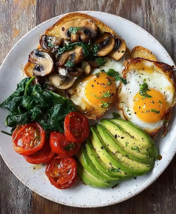 Delicious hearty breakfast plate with eggs, toast, and vegetables.