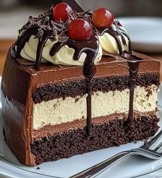 Delicious triple chocolate mousse cake topped with creamy chocolate ganache.