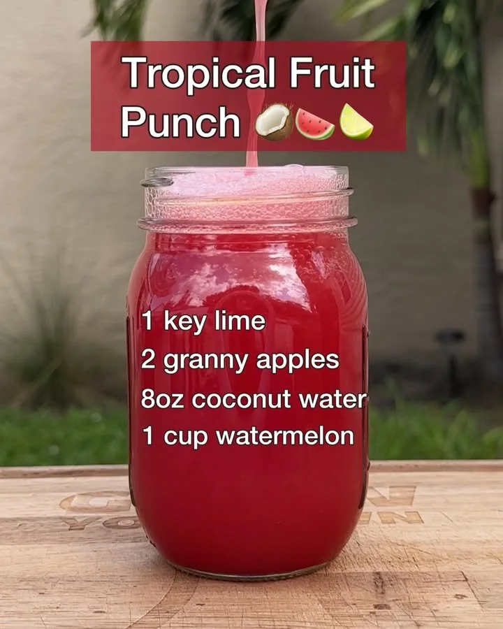 A colorful bowl of tropical fruit punch made with fresh fruit and vibrant juices.