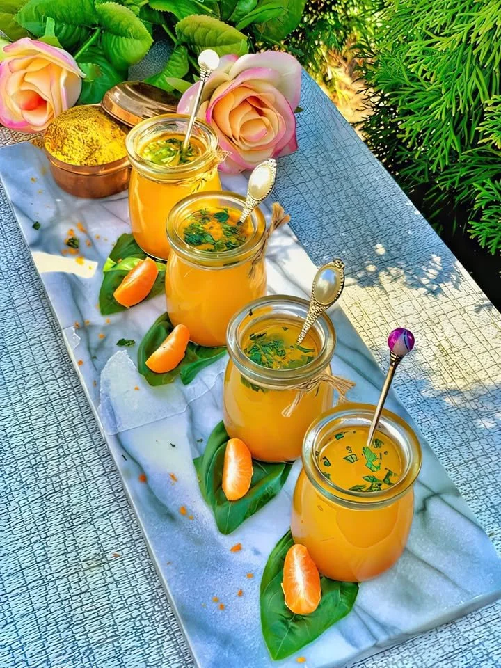 Turmeric ginger immune booster juice in a glass with fresh ingredients.