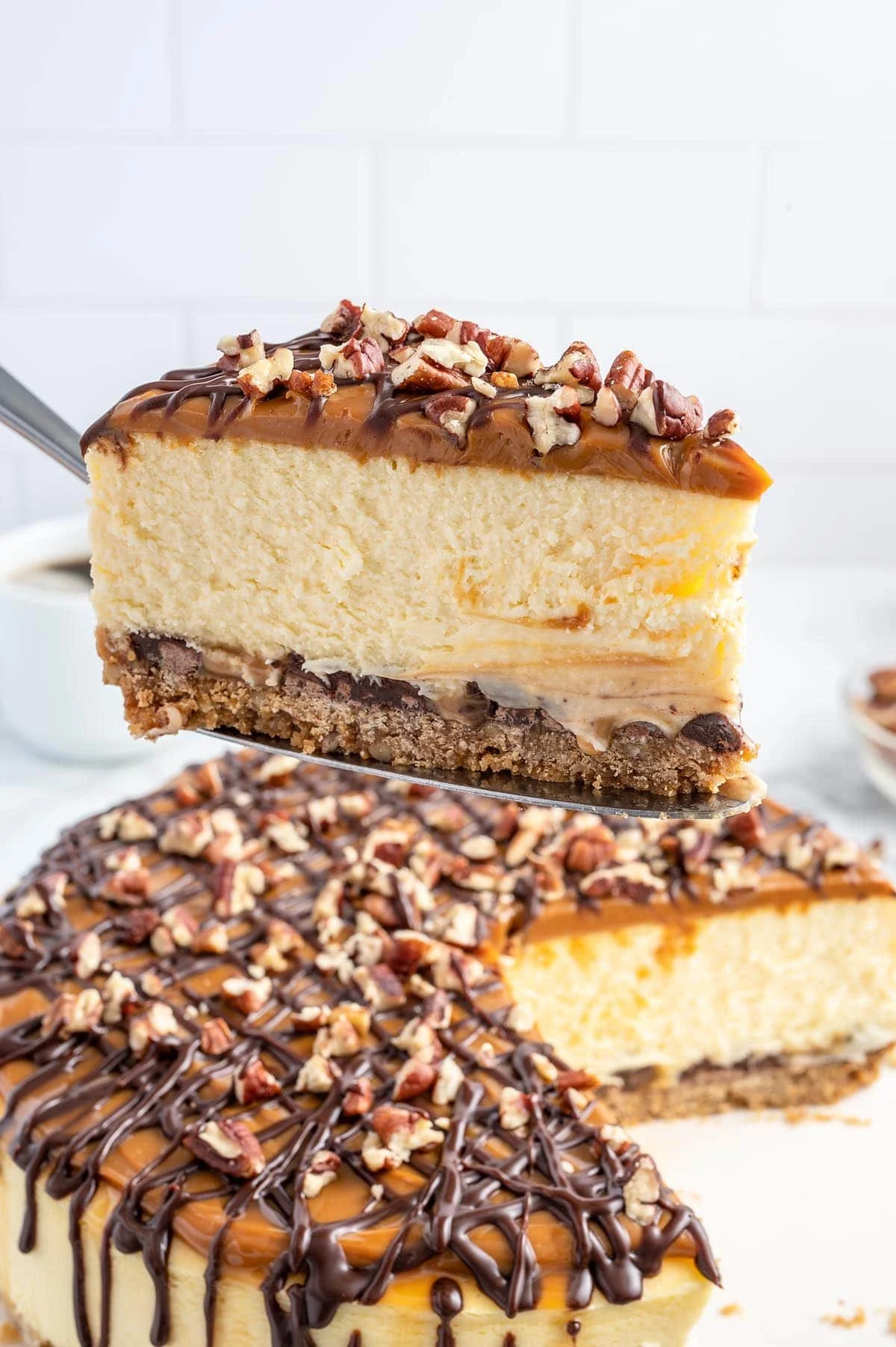 Delicious Turtle Cheesecake with caramel, chocolate, and pecans on a plate