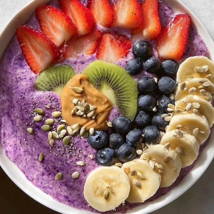 Vibrant berry smoothie bowl topped with fresh berries and nuts