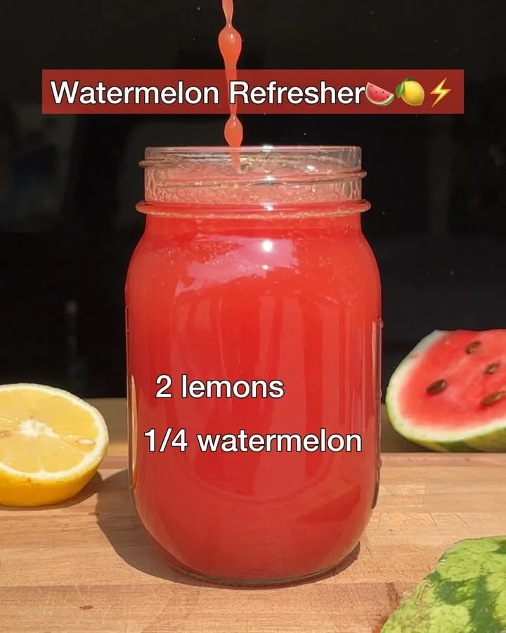 A refreshing Watermelon Refresher drink in a glass with ice and mint leaves.
