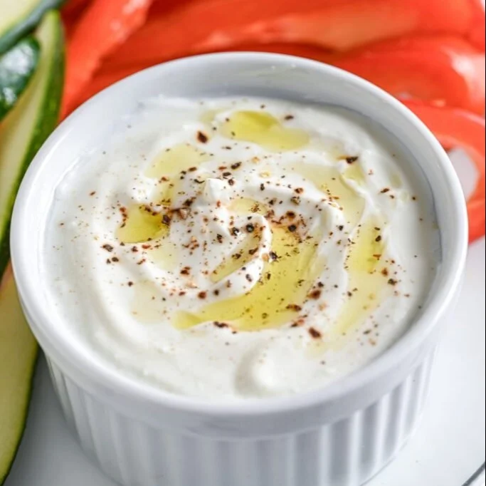 Delicious bowl of whipped cottage cheese topped with fresh fruits and nuts
