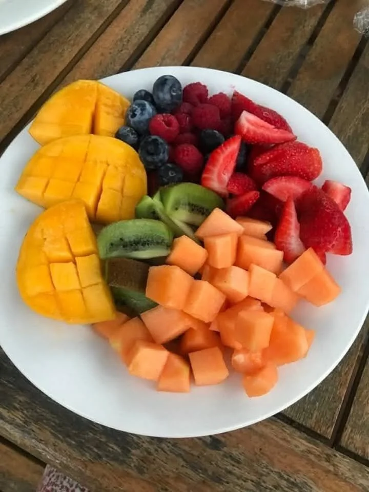 An assortment of delicious and colorful fruits including apples, bananas, and berries.