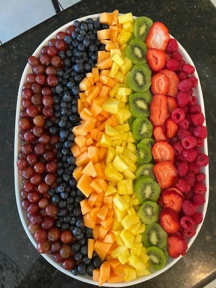A colorful assortment of yummy fruits displayed in a vibrant basket.