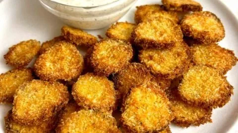 Crispy air fryer fried pickles served with a dipping sauce