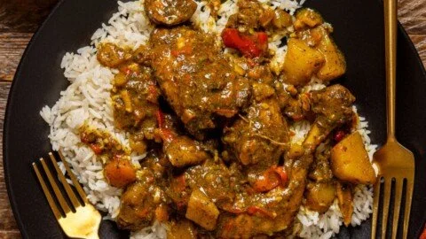Bowl of authentic Jamaican curry chicken with spices and vegetables