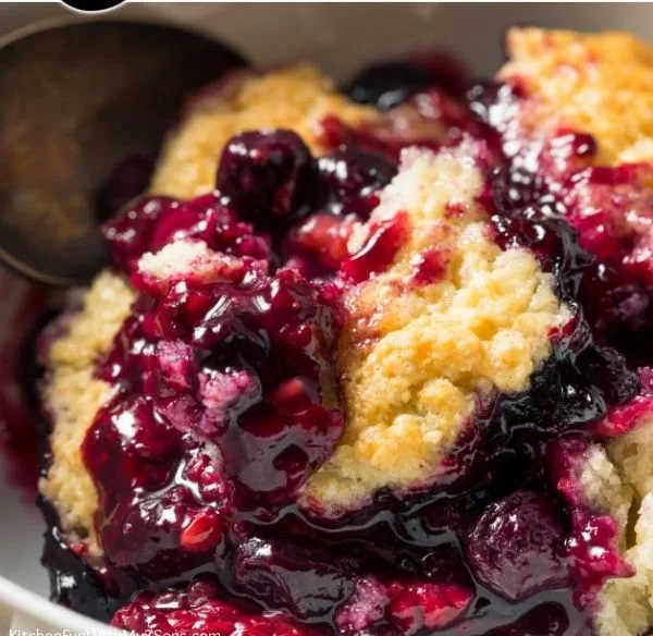 Delicious homemade berry cobbler topped with ice cream.