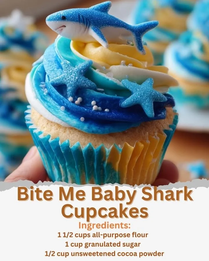 Bite Me Baby Shark Cupcakes decorated with colorful ocean-themed designs.