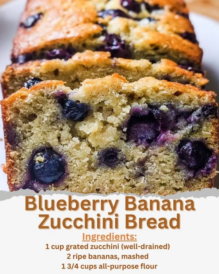 Loaf of blueberry banana zucchini bread sliced on a wooden cutting board