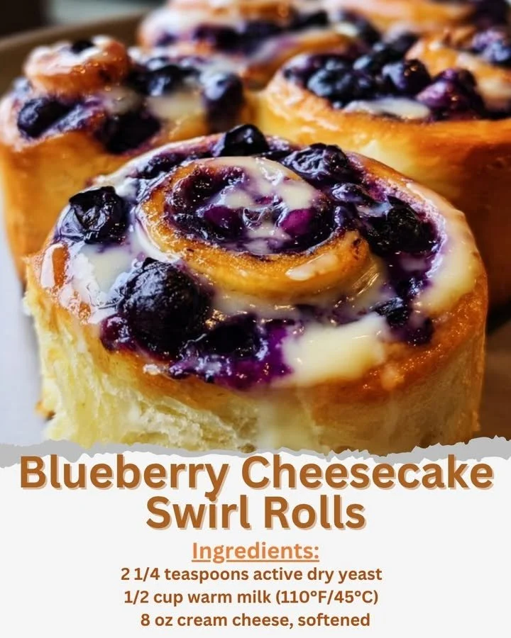 Blueberry cheesecake swirl rolls freshly baked and topped with blueberries.