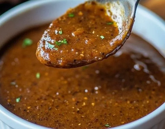 Bold and smoky Texas Roadhouse-style steak sauce in a garnished dish