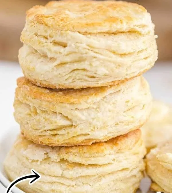 Freshly baked buttermilk biscuits served on a plate.