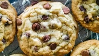 Freshly baked chocolate chip cookies on a cooling rack