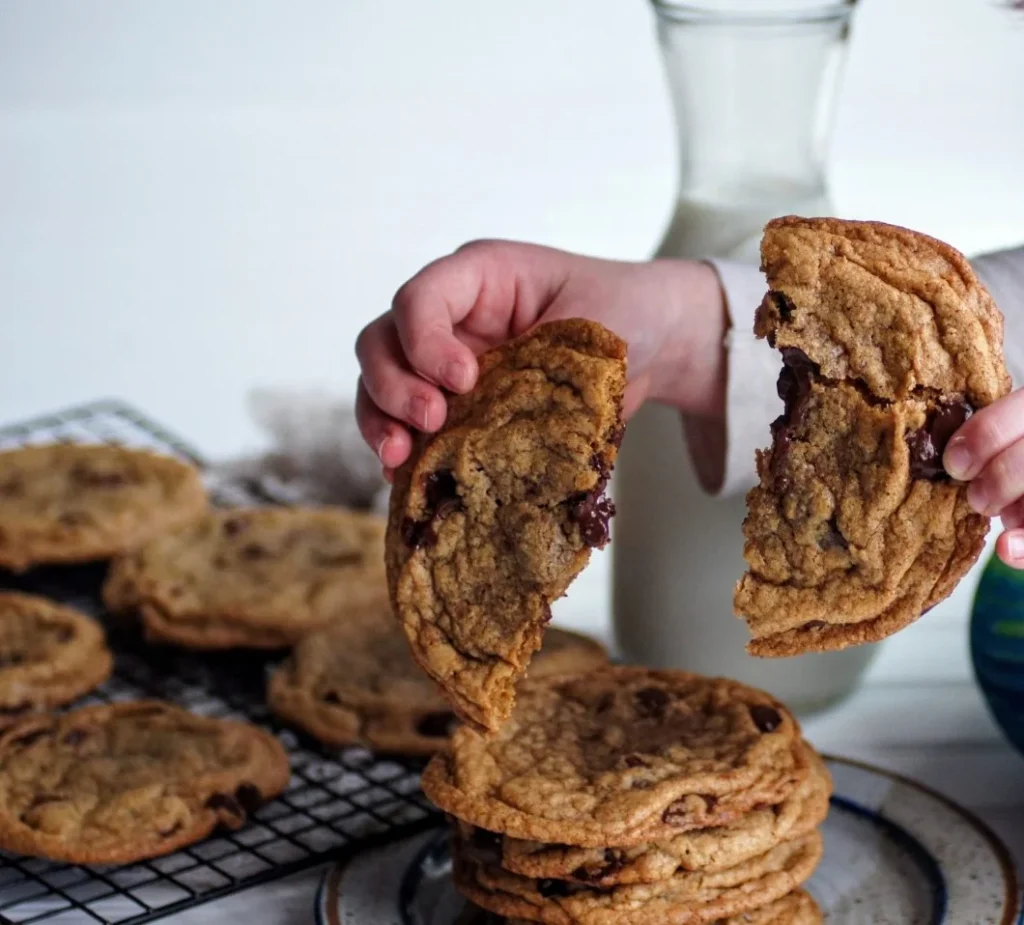 Freshly baked chocolate chip cookies on a cooling rack