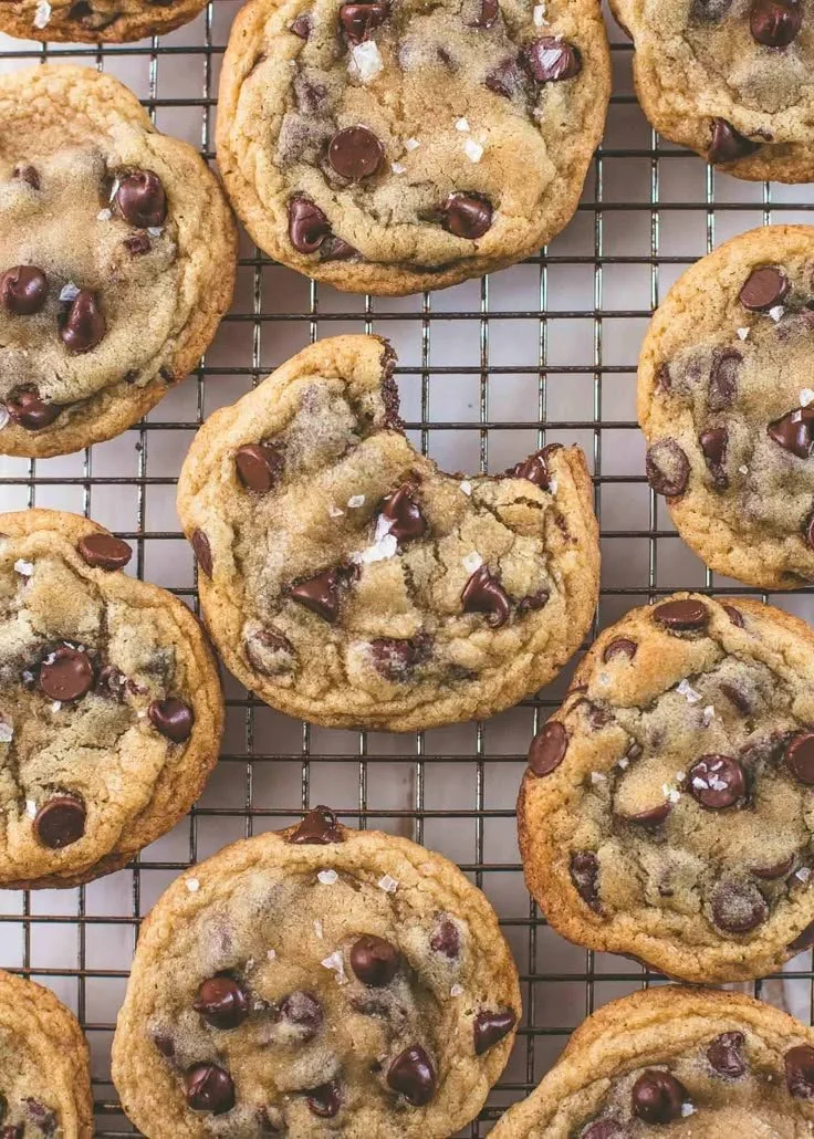 Freshly baked chocolate chip cookies on a cooling rack