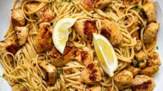 Plate of Cowboy Butter Chicken Linguine garnished with herbs and spices.