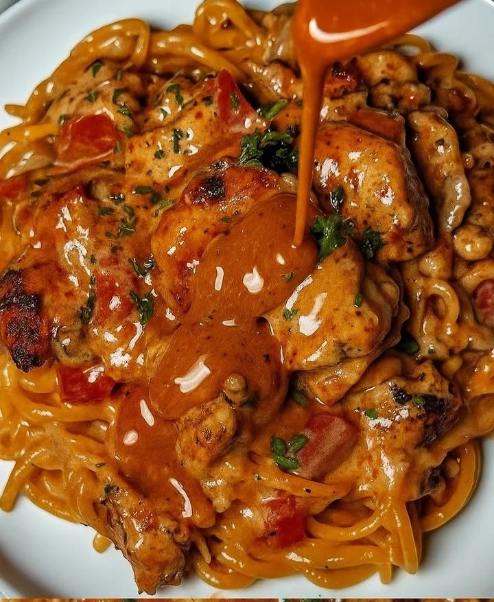 Plate of creamy Cajun Chicken Linguine garnished with herbs