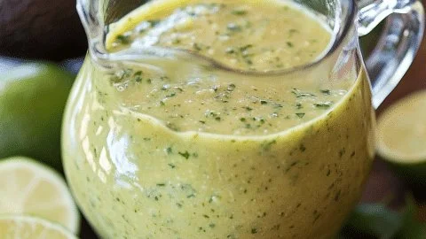 Creamy cilantro lime avocado salsa served in a bowl with tortilla chips.