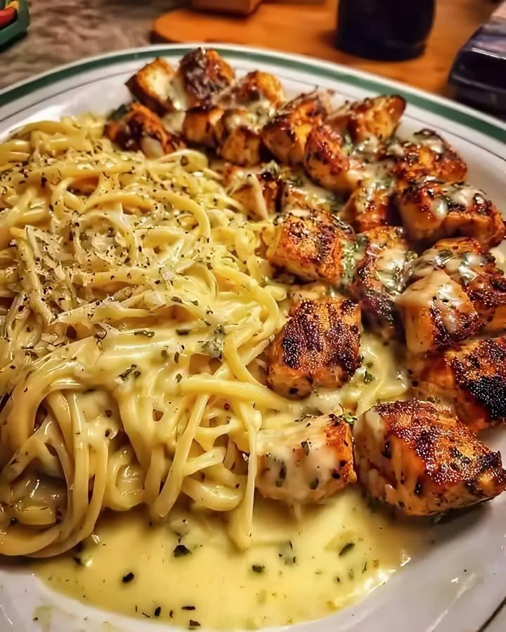 Plate of creamy garlic chicken served with linguine pasta