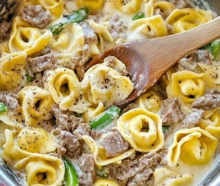Creamy Philly Cheesesteak Tortellini dish with cheese and seasonings