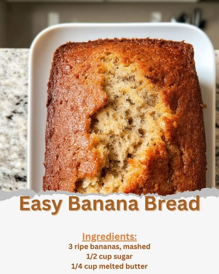 Sliced easy banana bread on a wooden cutting board with ripe bananas beside it