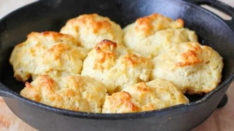 Freshly baked easy drop biscuits on a wooden table.
