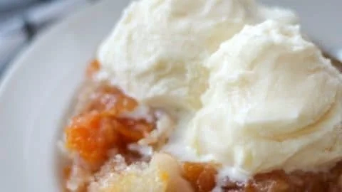 Delicious easy peach cobbler served in a baking dish with a golden crust.