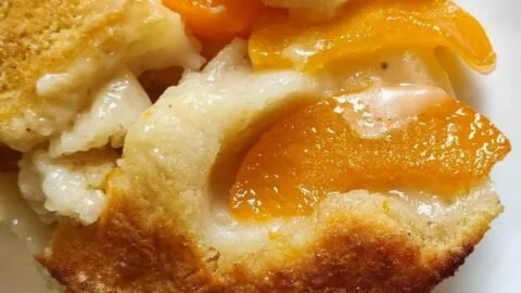 Delicious homemade easy peach cobbler served warm with ice cream