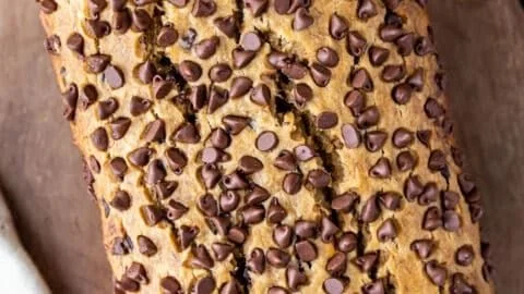 Slice of moist eggless banana bread on a wooden board