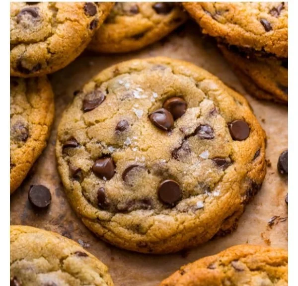 Freshly baked everyday chocolate chip cookies on a cooling rack.