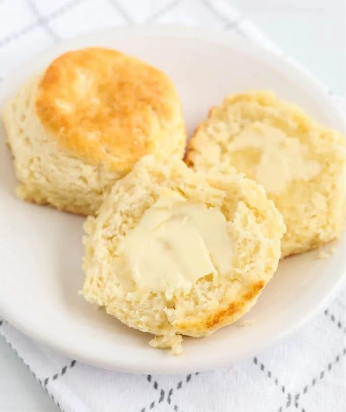 Fluffy Bisquick biscuits on a wooden table ready to serve