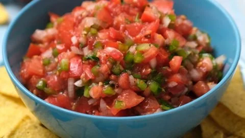 Bowl of fresh tomato salsa with cilantro and lime