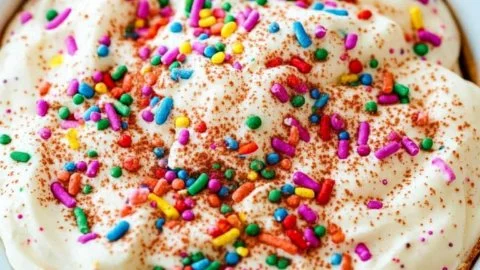 Creamy Funfetti Cake Dip with colorful sprinkles served in a bowl.