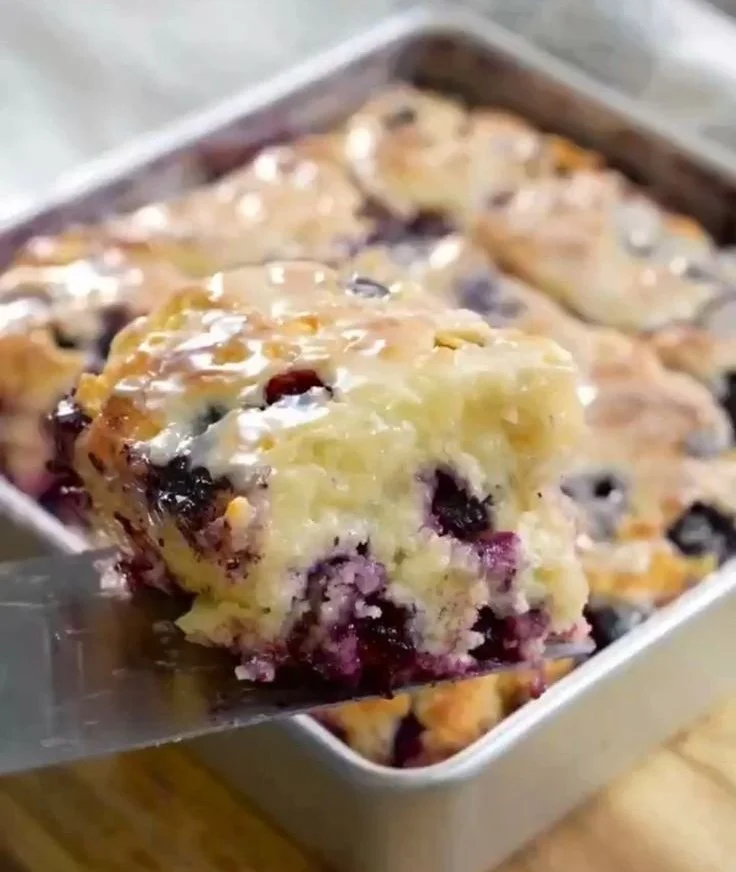 Glazed blueberry buttermilk swim biscuits on a plate