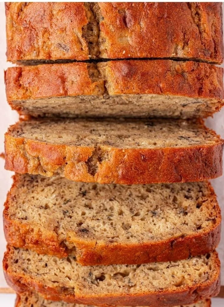 Slice of Greek Yogurt Banana Bread on a wooden table
