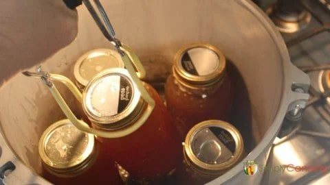 Jars of homemade chicken broth ready for canning and storage.