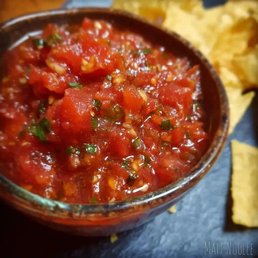 Bowl of homemade fire roasted tomato salsa with fresh ingredients