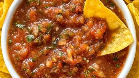 Bowl of vibrant homemade salsa with fresh ingredients and herbs