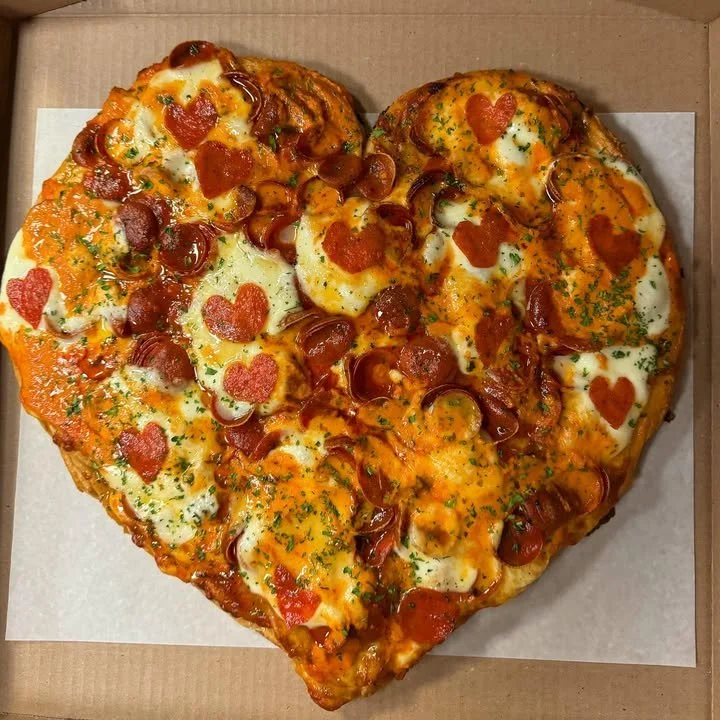 Heart-shaped Sicilian pizza with hot honey pepperoni and vodka sauce toppings.