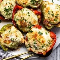 Italian stuffed peppers filled with rice, cheese, and herbs on a plate