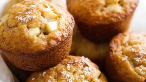 Jumbo Apple-Walnut Muffins fresh out of the oven, topped with walnuts.