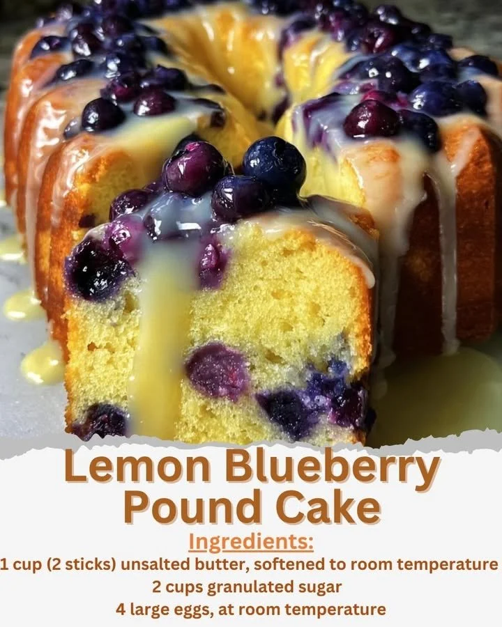 A freshly baked lemon blueberry pound cake with blueberries and lemon zest on display.