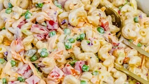 Delicious homemade Macaroni Salad served in a bowl with fresh vegetables