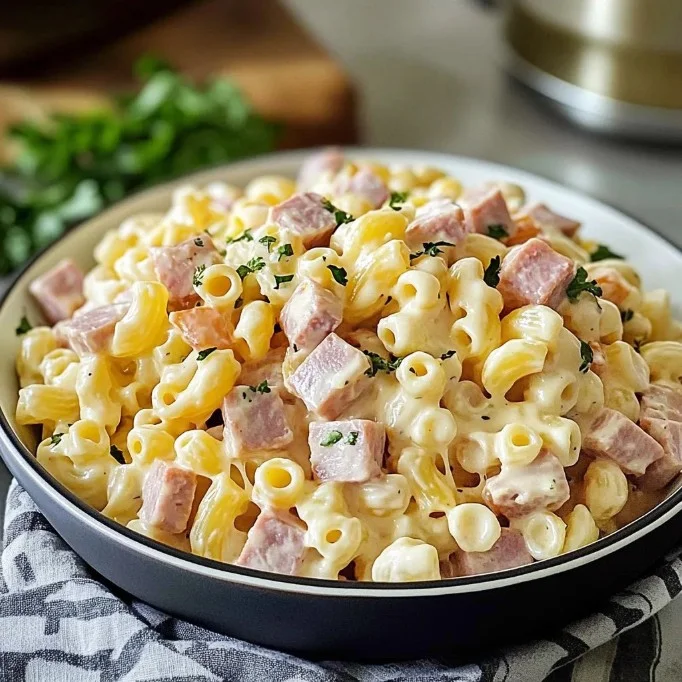 Delicious macaroni salad with ham and cheese served in a bowl