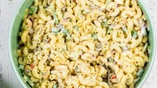 Bowl of old-fashioned macaroni salad with vegetables and dressing