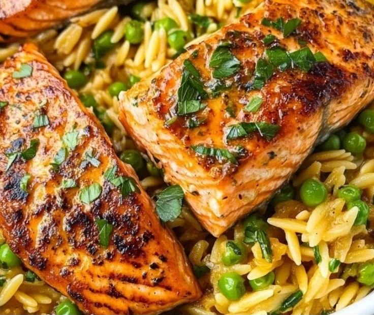 One-Pan Lemon Orzo with Salmon dish garnished with lemon and herbs
