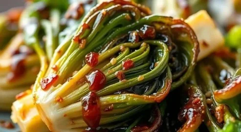 Oven-roasted bok choy with garlic and soy glaze on a serving plate