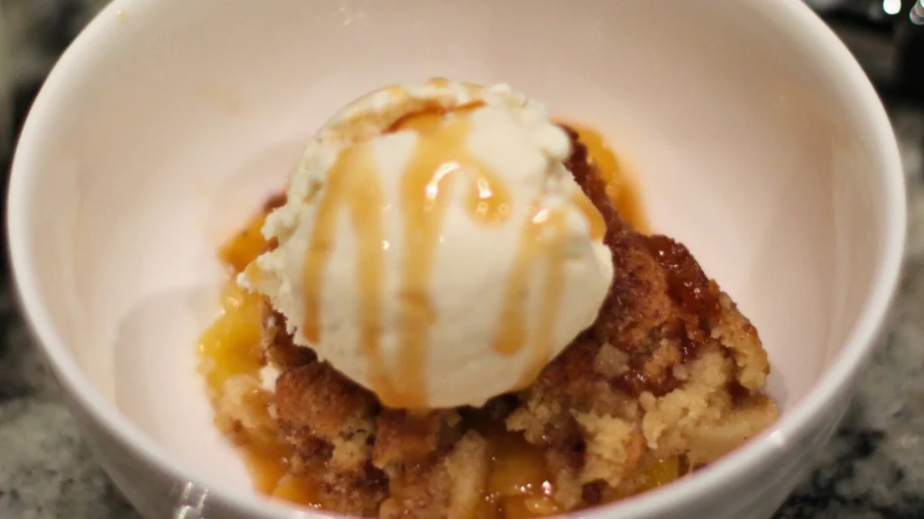 Homemade Peach Cobbler with golden crust and fresh peaches